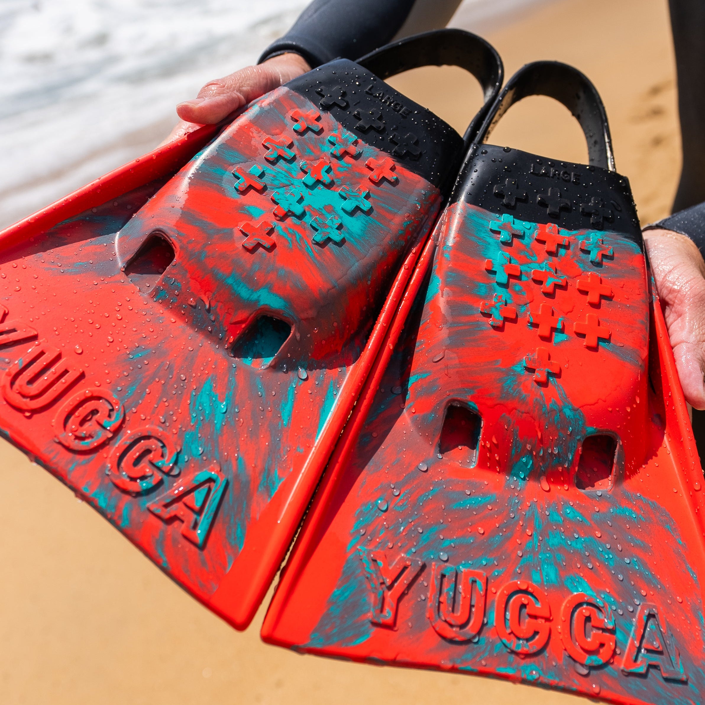 Yucca Sir Wiggins Short Blade Fins - Standard Flex - Yucca Fins swim fins held on a beach.