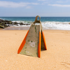 Yucca Primo Short Blade Fins - Super Flex - Yucca Fins on a sandy beach with ocean in the background